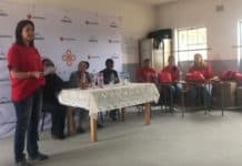 Trek4Mandela benefits Eastern Cape school girls Lee-Ann King from LexisNexis handing over donation to school